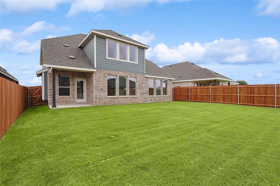 Rear view of house featuring a yard