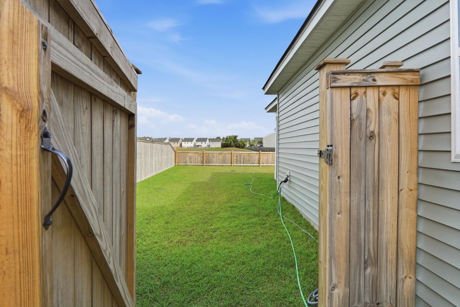Exterior details and patio area of a home in Sanctuary Cove at Cane Bay, Summerville (Image 34).