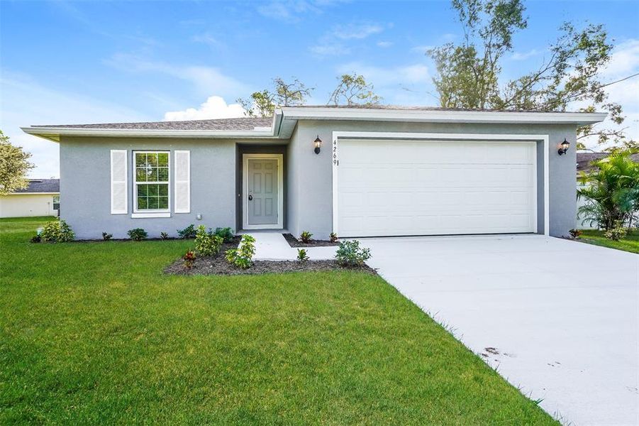 Front exterior of a new home in , North Port, FL, highlighting curb appeal (Image 1).