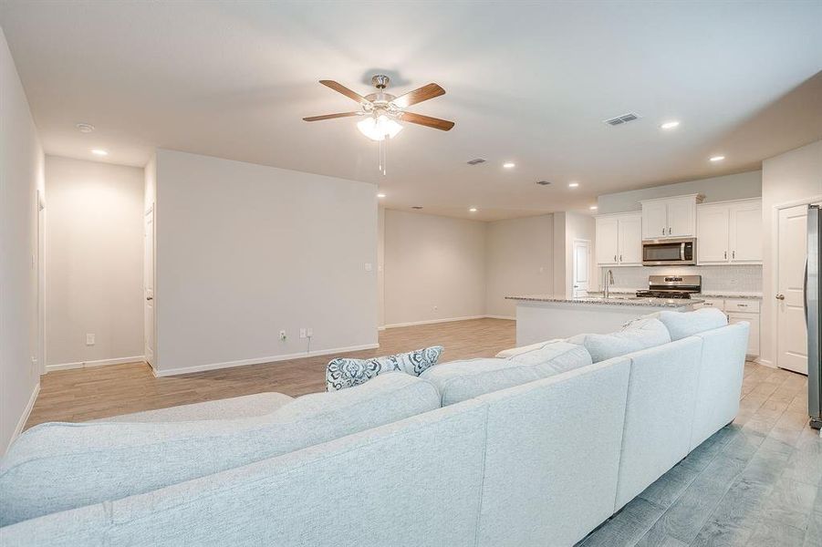 Living area featuring recessed lighting, light wood-style floors, and ceiling fan