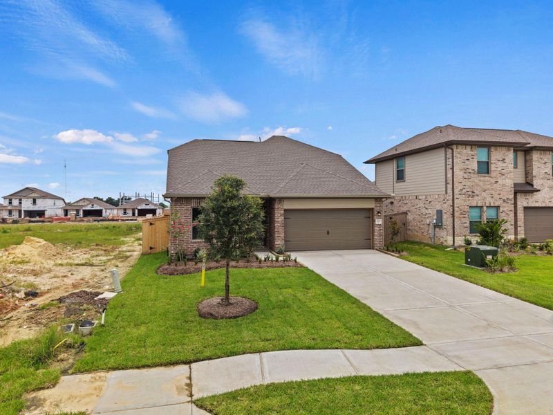 Front exterior of a new home in Windrose Green, Angleton, TX, highlighting curb appeal (Image 1). Front exterior of a new home in Windrose Green, Angleton, TX, highlighting curb appeal (Image 1).