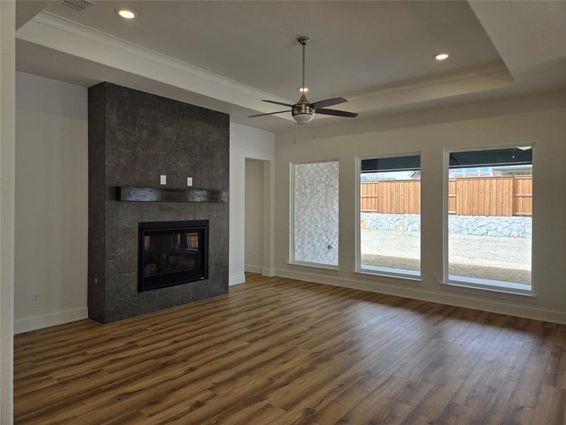 Plenty of family memories to be made in this gorgeous family room featuring floor to ceiling picture windows, beautiful fireplace and lovely wood look flooring!