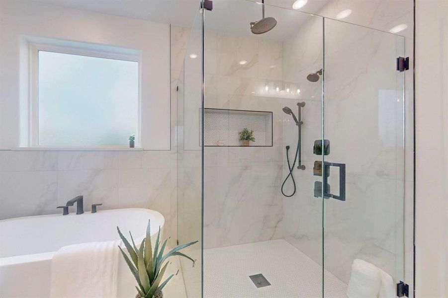 Bathroom with a freestanding bath and a marble finish shower Bathroom with a freestanding bath and a marble finish shower
