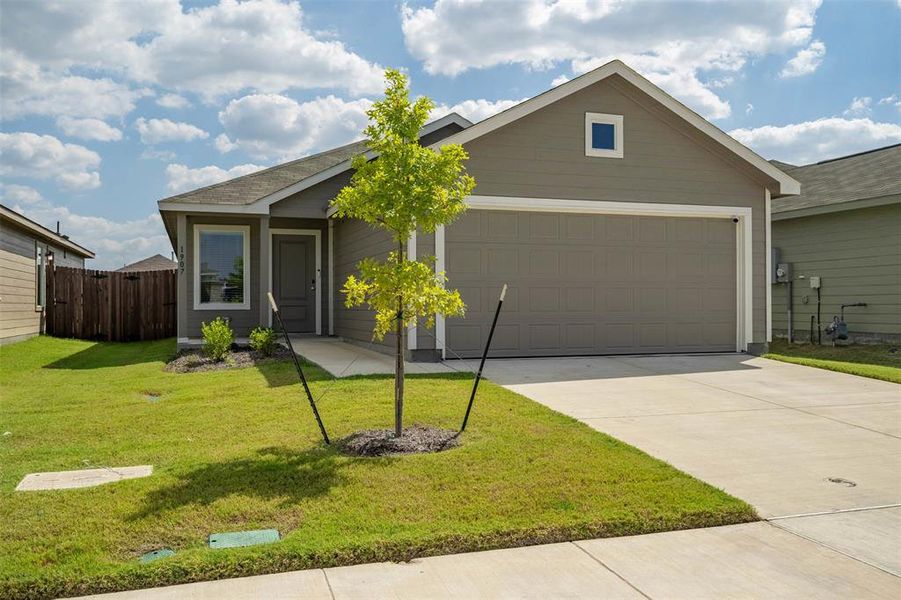 View of front facade featuring concrete driveway and an attached garage View of front facade featuring concrete driveway and an attached garage