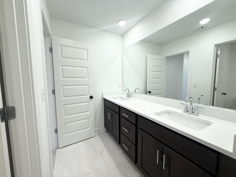 Full bath with double vanity and recessed lighting