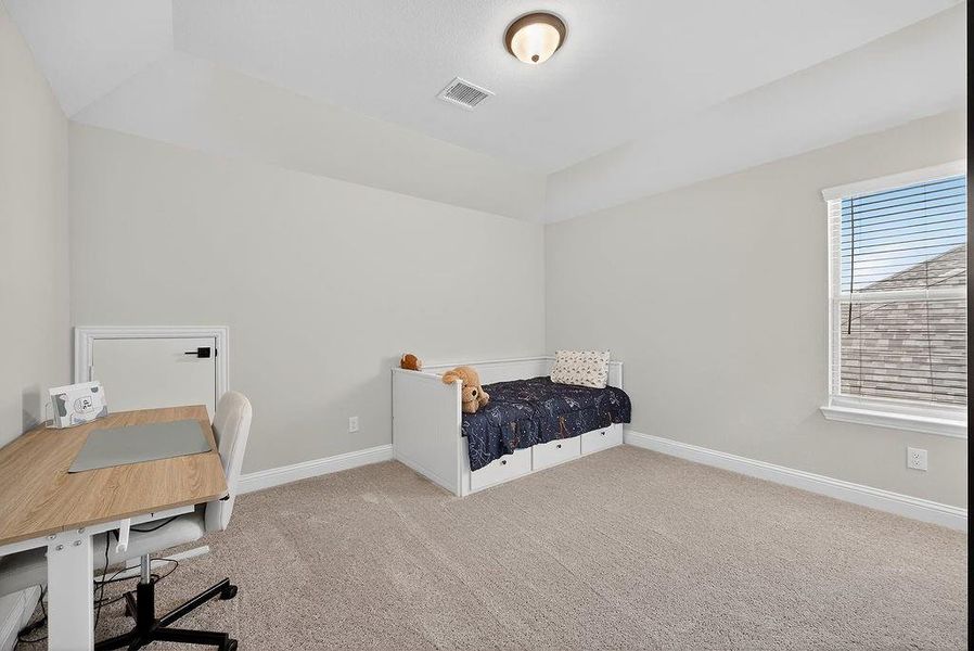 Carpeted room featuring a recessed ceiling, a window with blinds, and neutral wall tones