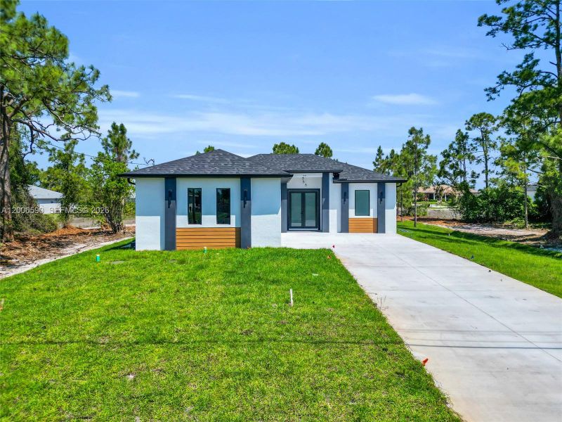 Front exterior of a new home in , Lehigh Acres, FL, highlighting curb appeal (Image 27).