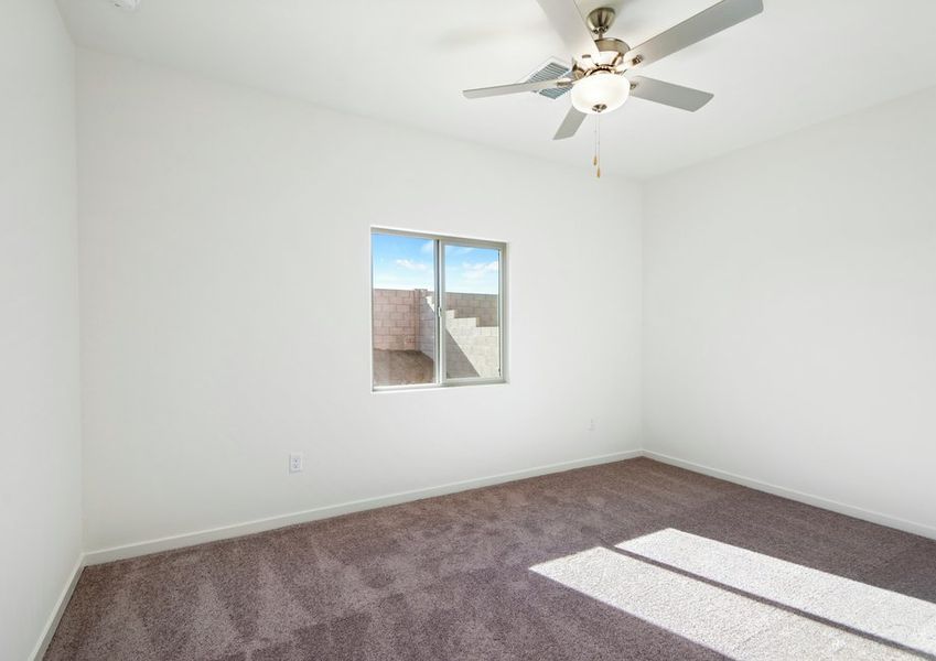 Windows let in plenty of natural light to this master bedroom.