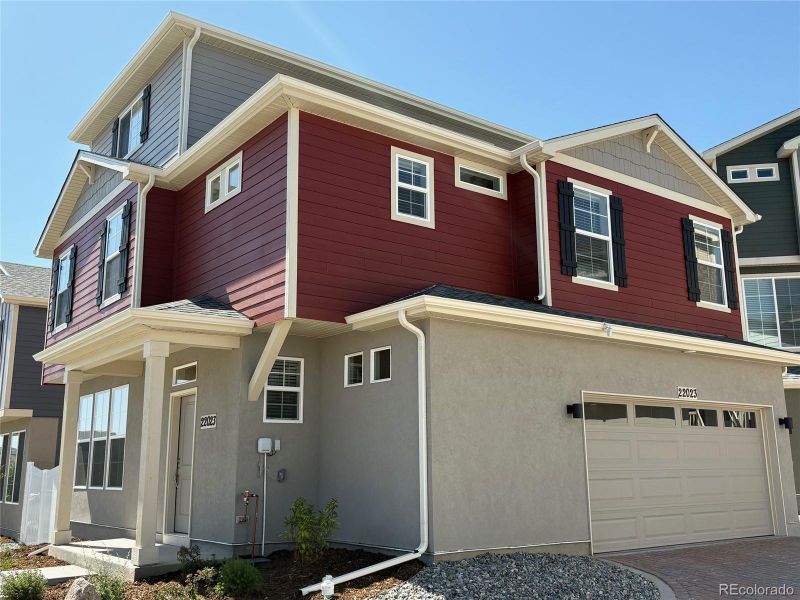 Front exterior of a new home in Green Valley Ranch, Aurora, CO, highlighting curb appeal (Image 23).