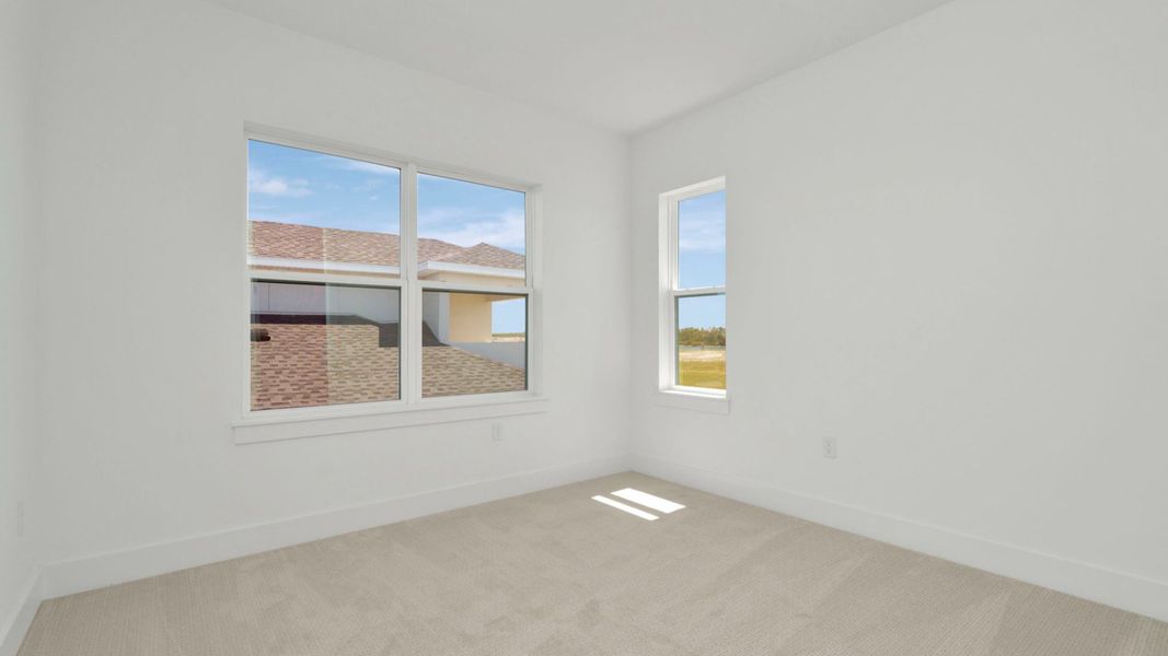 The Fourth Bedroom of a DRB Homes Grand Hawk which is offered as a home plan at Serengeti in Spring Hill, FL.