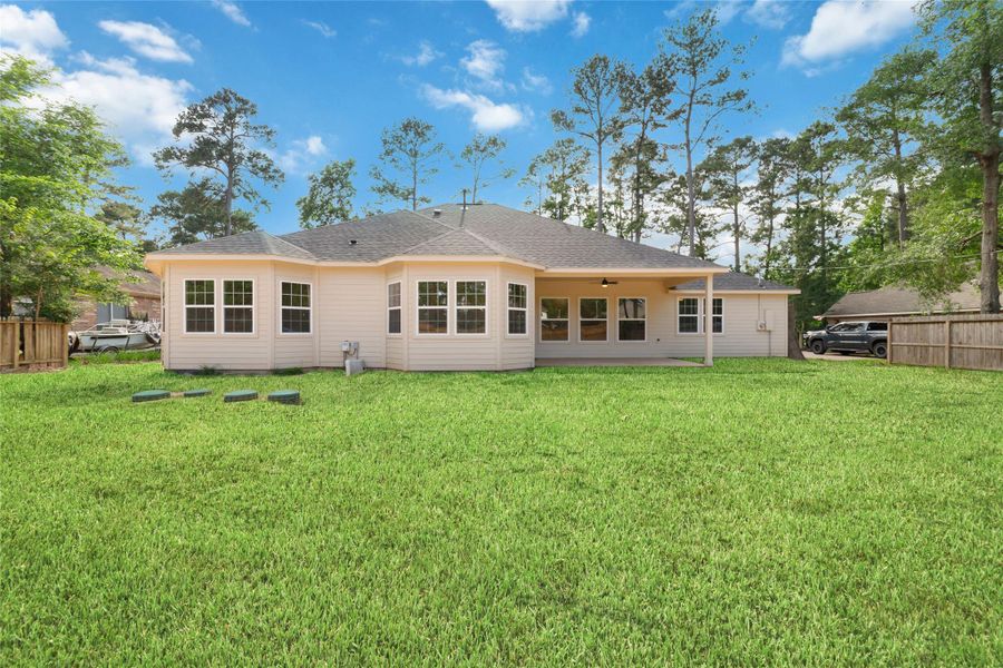 View of the back exterior of the house. This is representative of what it will look like with grass. Currently, it is mostly dirt as construction has just been completed. View of the back exterior of the house. This is representative of what it will look like with grass. Currently, it is mostly dirt as construction has just been completed.