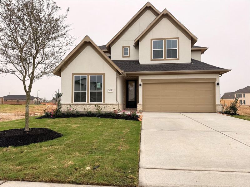 Front exterior of a new home in Elyson 45' & 70', Katy, TX, highlighting curb appeal (Image 2).