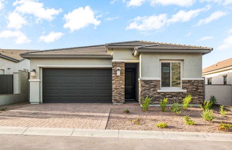 Front exterior of a new home in Regent Hills - Meadow Series, Buckeye, AZ, highlighting curb appeal (Image 2). Front exterior of a new home in Regent Hills - Meadow Series, Buckeye, AZ, highlighting curb appeal (Image 2).