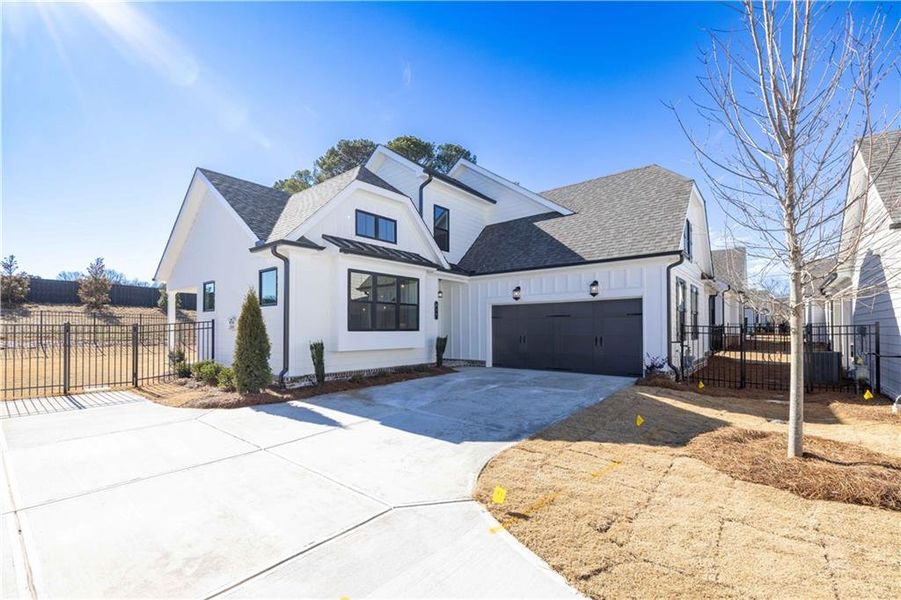 Front exterior of a new home in Promenade at Sawnee Village, Cumming, GA, highlighting curb appeal (Image 1). Front exterior of a new home in Promenade at Sawnee Village, Cumming, GA, highlighting curb appeal (Image 1).
