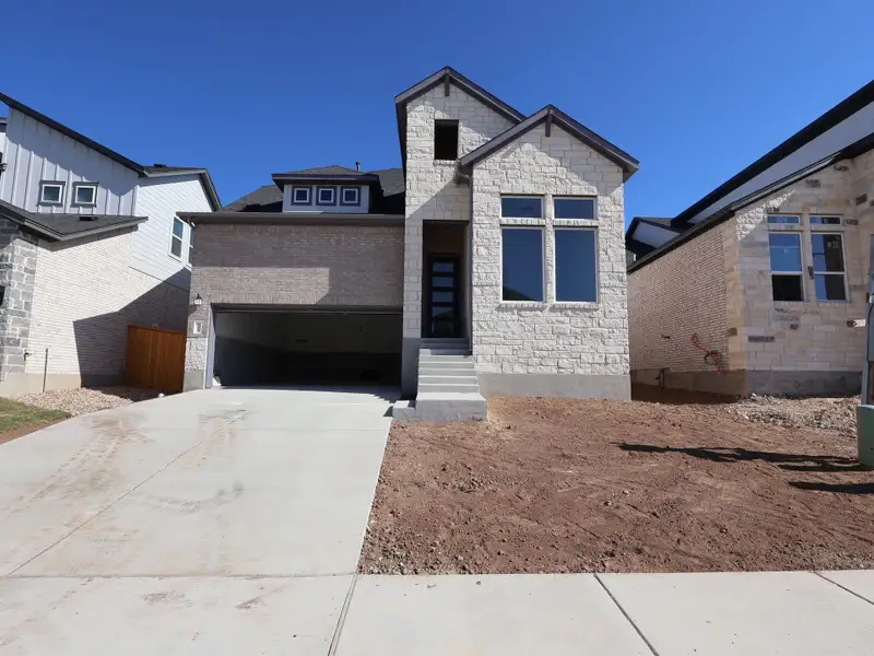 Front exterior of a new home in Cedar Brook, Leander, TX, highlighting curb appeal (Image 1). Front exterior of a new home in Cedar Brook, Leander, TX, highlighting curb appeal (Image 1).