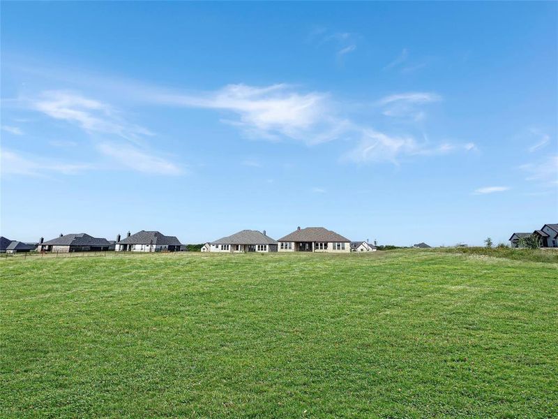 Backyard! *Grass Virtually staged to show what it could look like!* CORNER LOT so could have a large workshop in the backyard with a driveway directly to it. 3 Car Garage is on side of the house. Backyard! *Grass Virtually staged to show what it could look like!* CORNER LOT so could have a large workshop in the backyard with a driveway directly to it. 3 Car Garage is on side of the house.
