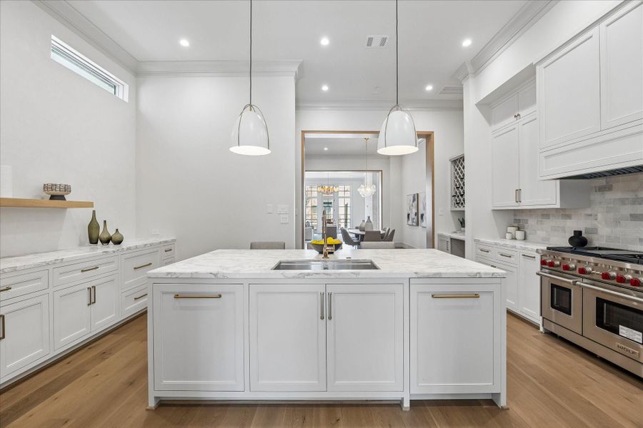 All the kitchen cabinets feature inset, soft-close doors and drawers. The drawers have undermount hardware to keep them quiet and fully accessible. The back splash is tumbled marble, giving a subtle contrast to the countertops of the same polished marble.
