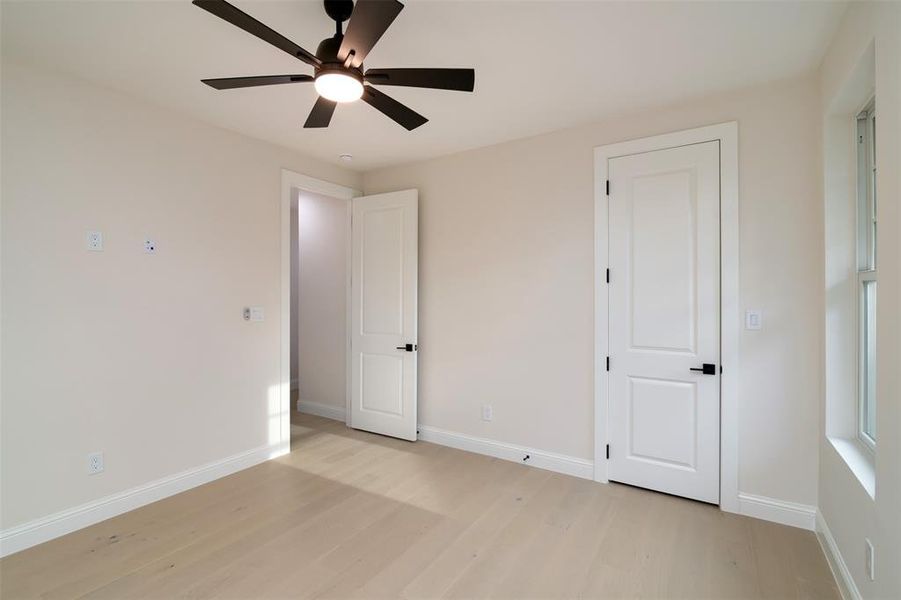 Unfurnished bedroom featuring light hardwood / wood-style flooring and ceiling fan