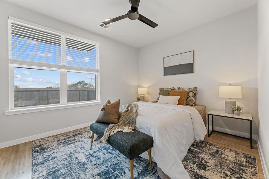 Bedroom featuring wood finished floors and ceiling fan