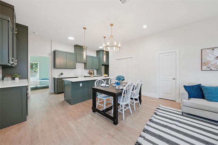 Dining area featuring light wood finished floors, recessed lighting, and a chandelier