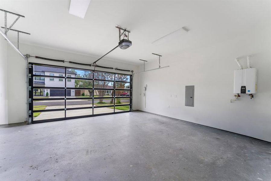 Garage with electric panel, a garage door opener, and tankless water heater Garage with electric panel, a garage door opener, and tankless water heater