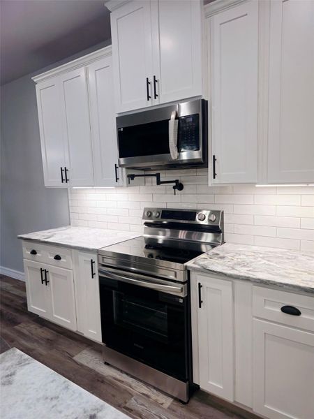 Pot filler over the stove and subway tile backsplash