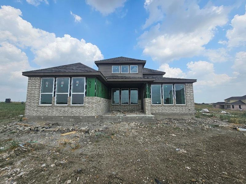 Rear view of property with stone siding Rear view of property with stone siding