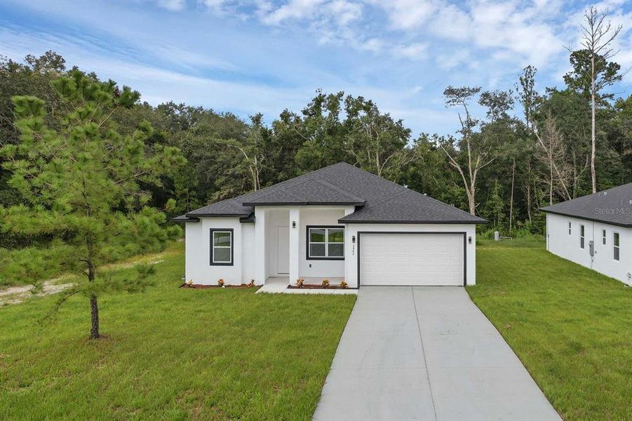 Front exterior of a new home in , Rotonda West, FL, highlighting curb appeal (Image 1). Front exterior of a new home in , Rotonda West, FL, highlighting curb appeal (Image 1).