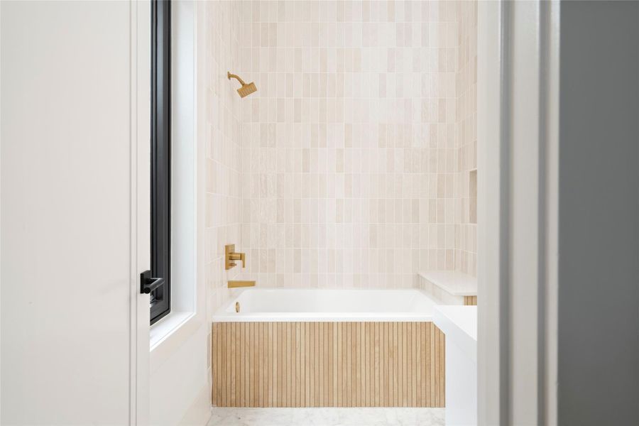 Ensuite bath featuring elegant quartz, and a beautiful tile-wrapped shower.