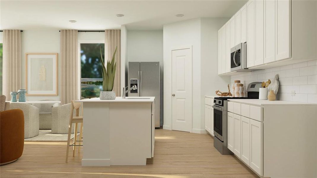 Kitchen featuring backsplash, a kitchen island with sink, white cabinets, a breakfast bar area, and stainless steel appliances