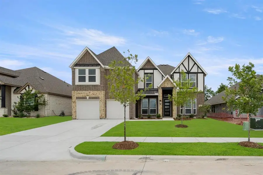 Front exterior of a new home in Oaks of North Grove, Waxahachie, TX, highlighting curb appeal (Image 2).