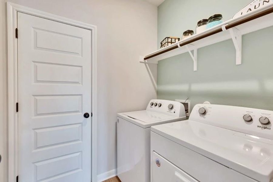 Washroom featuring laundry area, baseboards, and washer and clothes dryer