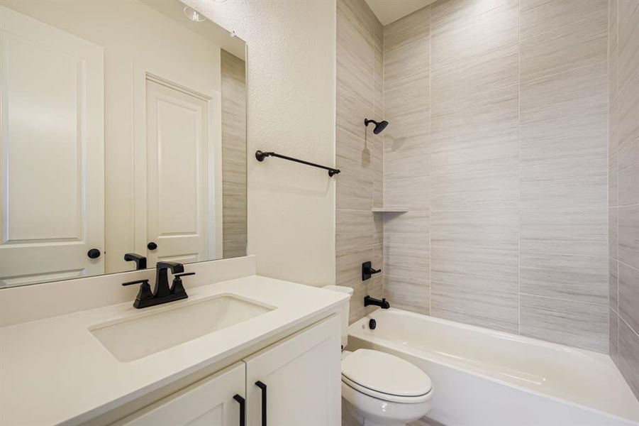 Full bathroom featuring shower / tub combination and vanity