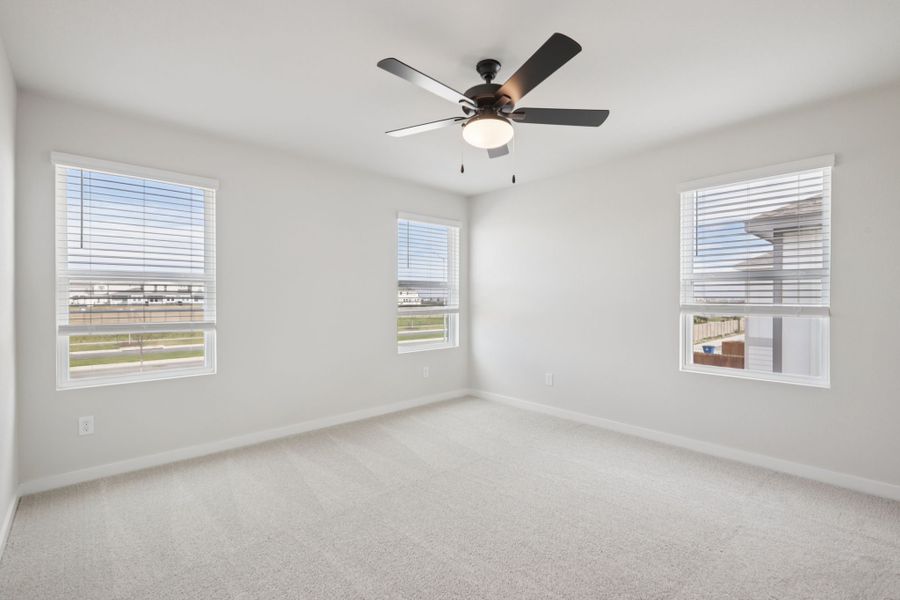 A room with a ceiling fan and a window.