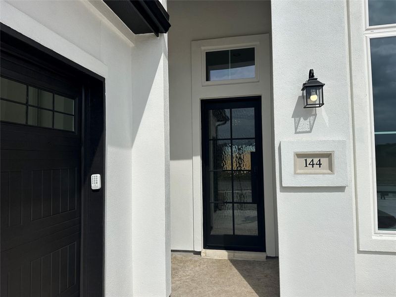 View of exterior entry featuring stucco siding