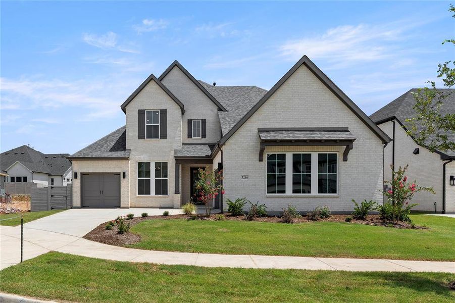 Front exterior of a new home in Painted Tree Woodlands, McKinney, TX, highlighting curb appeal (Image 1).