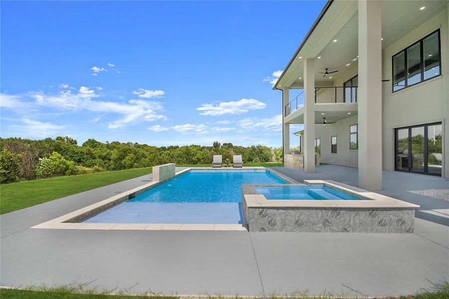 View of pool featuring a ceiling fan, a patio, and a pool with connected hot tub