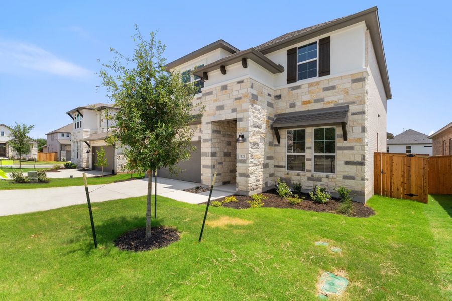 Front exterior of a new home in Heritage, Dripping Springs, TX, highlighting curb appeal (Image 29).