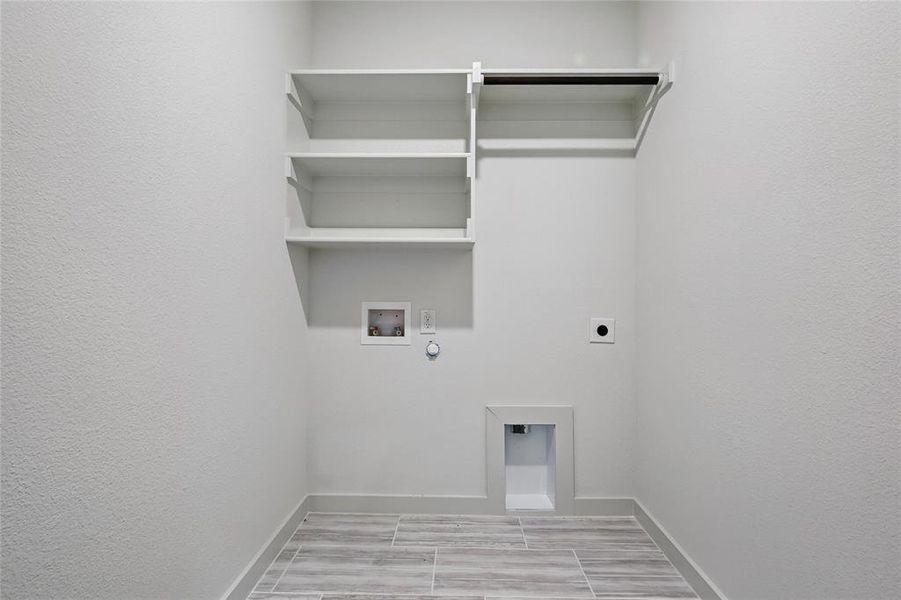 Laundry area with washer hookup, electric dryer hookup, laundry area, baseboards, and gas dryer hookup Laundry area with washer hookup, electric dryer hookup, laundry area, baseboards, and gas dryer hookup