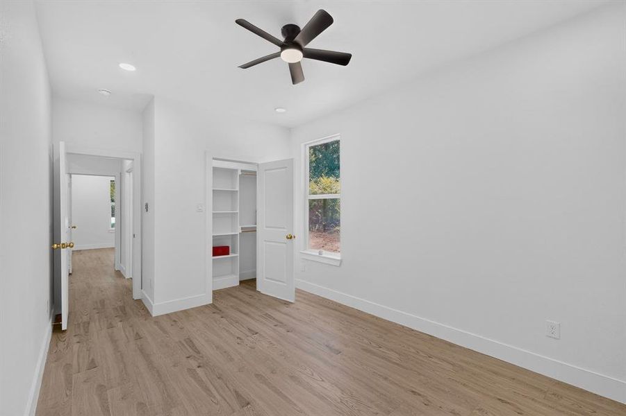Light wood-finish flooring complements the crisp white walls and trim