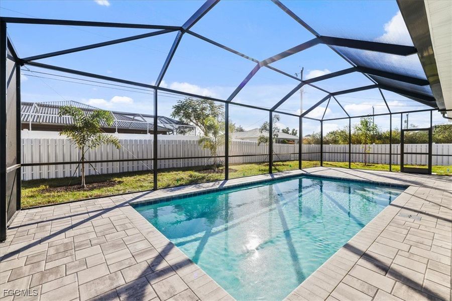 View of pool with a sunroom, a lanai, a fenced backyard, and a patio