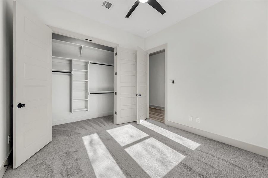 Unfurnished bedroom with carpet floors, a closet, and ceiling fan