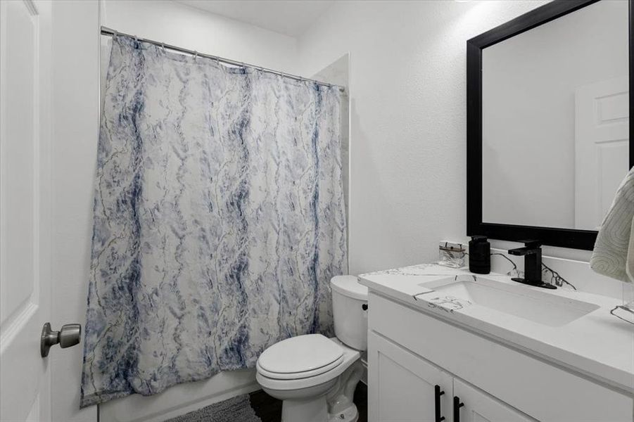 Bathroom featuring vanity and shower / tub combo Bathroom featuring vanity and shower / tub combo