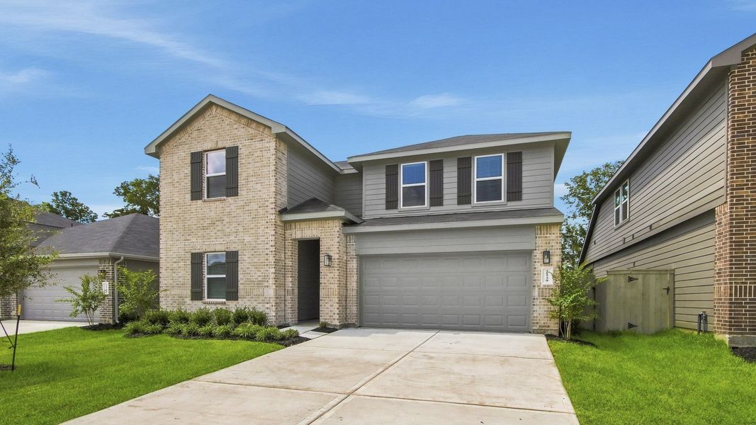 Front exterior of a new home in Harrington Trails at The Canopies, Splendora, TX, highlighting curb appeal (Image 2). Front exterior of a new home in Harrington Trails at The Canopies, Splendora, TX, highlighting curb appeal (Image 2).