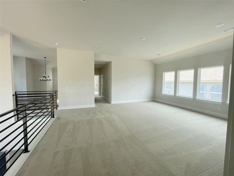 A spacious upper-level living area with ample natural light offers a perfect gathering spot. A spacious upper-level living area with ample natural light offers a perfect gathering spot.