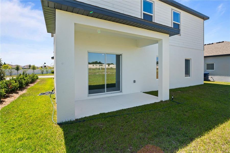 Exterior details and patio area of a home in Peach Crossings, Winter Haven (Image 3).