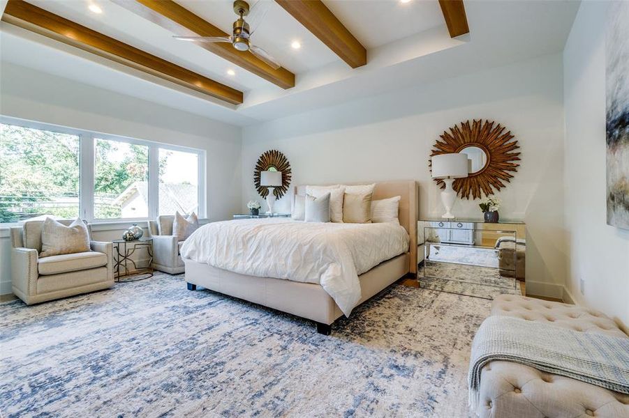 primary bedroom features trayed ceiling with beams