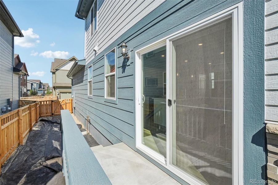 Front exterior of a new home in Woodrose at Painted Prairie, Aurora, CO, highlighting curb appeal (Image 22).