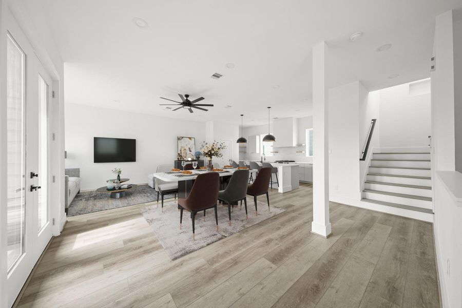 Perfect for daily living and entertaining, this home features an open layout with an abundance of natural light that connects the kitchen, dining and living areas. This photo has been staged. Perfect for daily living and entertaining, this home features an open layout with an abundance of natural light that connects the kitchen, dining and living areas. This photo has been staged.