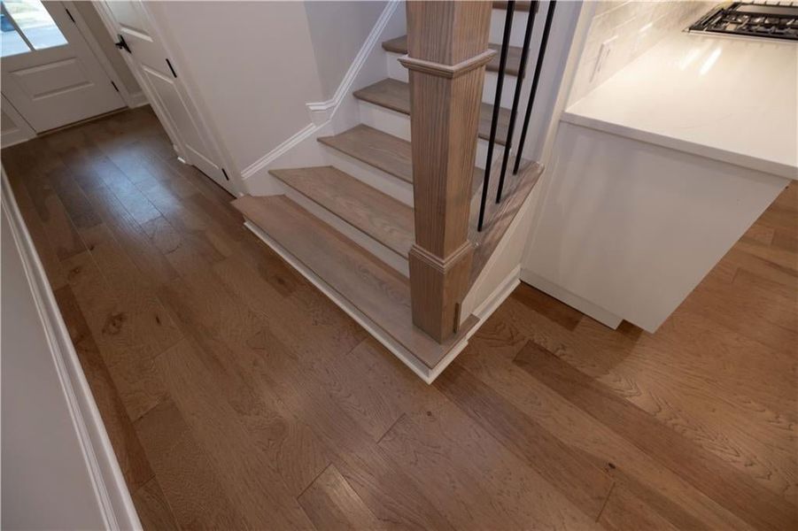 Stairway featuring hardwood / wood-style flooring and baseboards